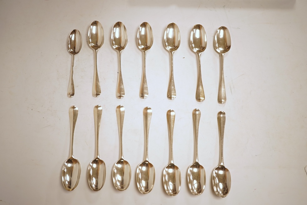 A matched set of seven Queen Anne silver Hanoverian pattern dessert spoons, maker's mark rubbed, five London, 1708, 17.5cm, together with seven other silver base mark Hanoverian pattern dessert spoons, various dates and